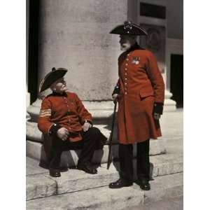  Two Pensioners in Signature Scarlet Coats, Outside of a 