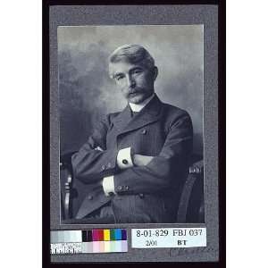   pinstripe suit seated with his arms crossed 1900